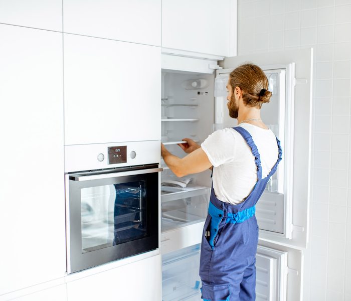 workman-installing-fridge-on-the-kitchen-at-home-2021-09-02-09-20-03-utc.jpg